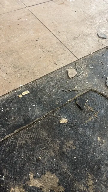 Black bitumen mastic floor removal in a SW11 flat